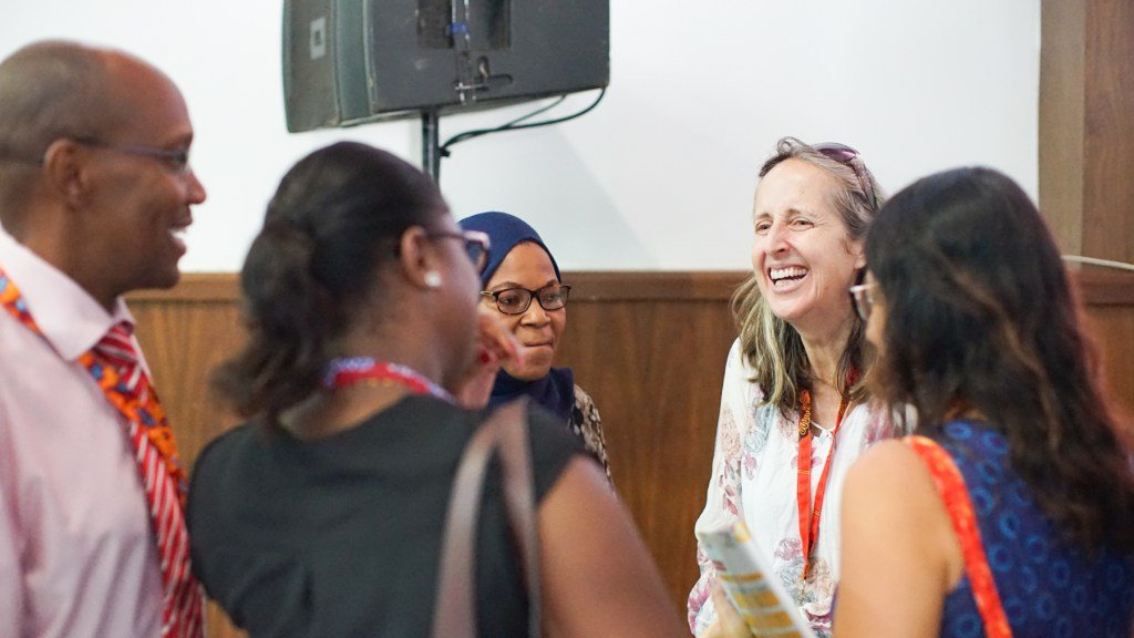 Dr. Trish Scanlan in conversation with panel audience members at the AORTIC conference in Maputo. (Noah Smith/ Direct Relief)