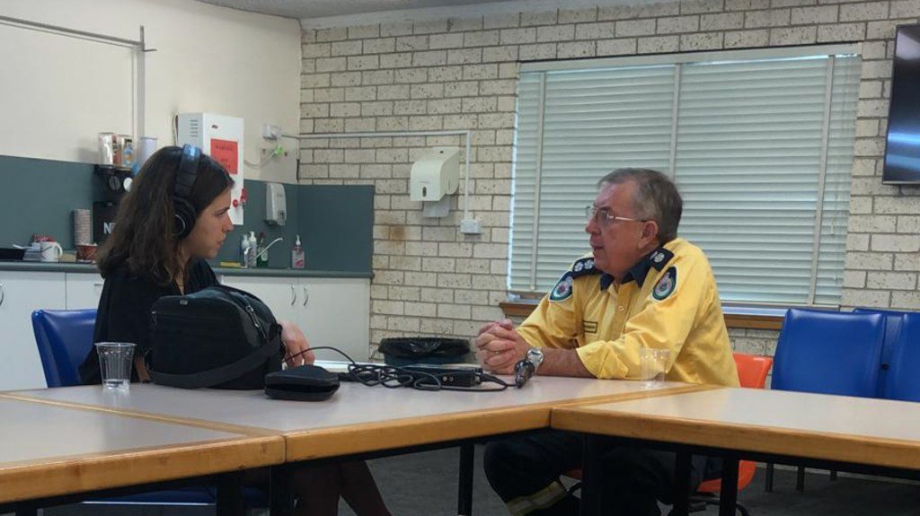 Phil Hurst speaking with Amarica Rafanelli (Chris Alleway/ Direct Relief)