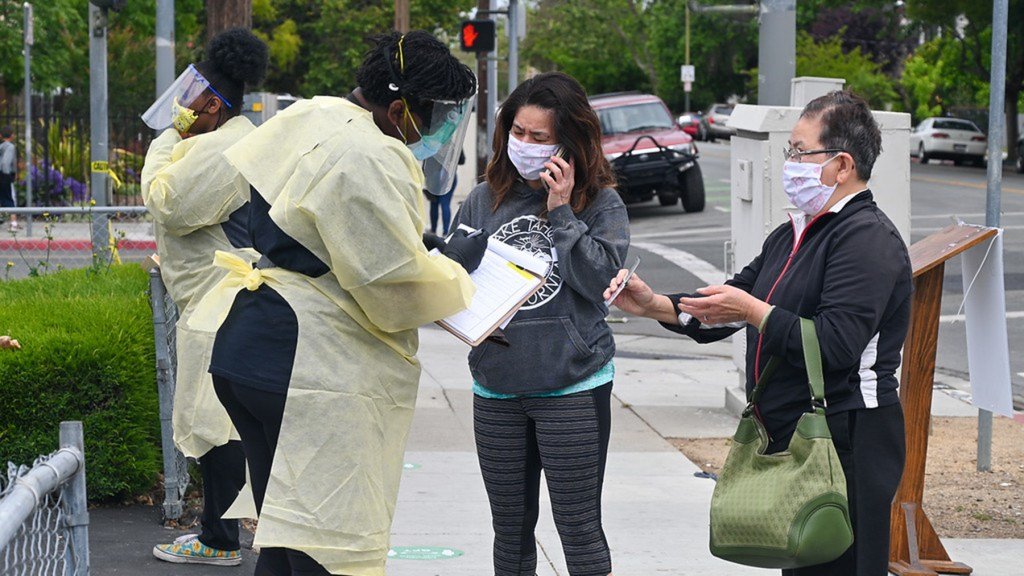 A Roots Community Health Center staff member checks people in to be tested. (Photo courtesy of Roots Community Health Center)
