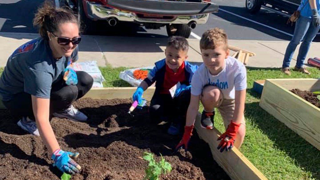 Young gardeners pose at Coastal Family Health Center's children's garden. (Photo courtesy of Coastal Family Health Center)