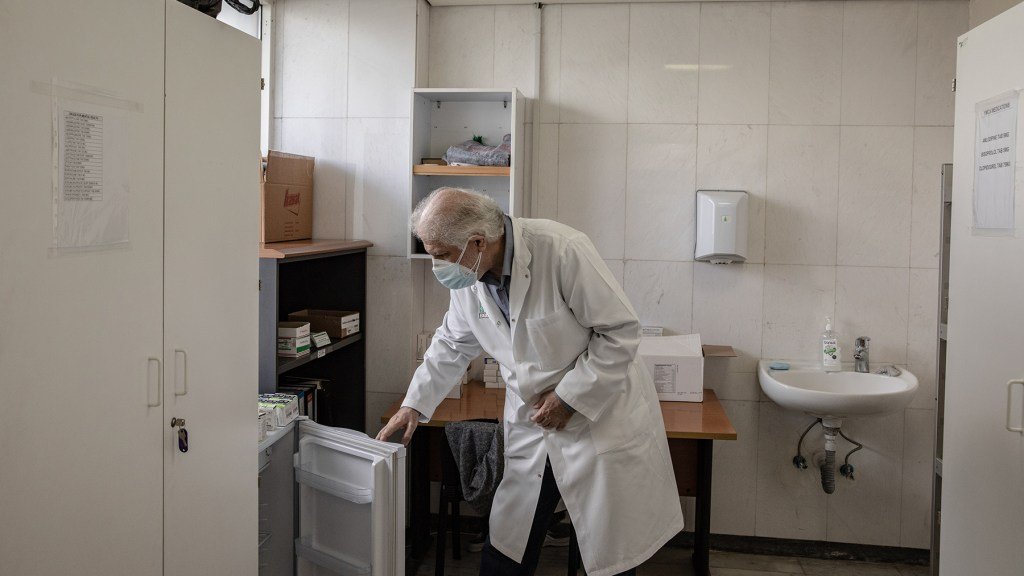 Dr. Akram Chtay, looking into a fridge containing Direct Relief-donated insulin in the pharmacy of the Rafik Hariri University Hospital, Beirut, Lebanon. Direct Relief has been able to provide critical donations to the facility since 2020's explosion. (Photo by Francesca Volpi for Direct Relief)