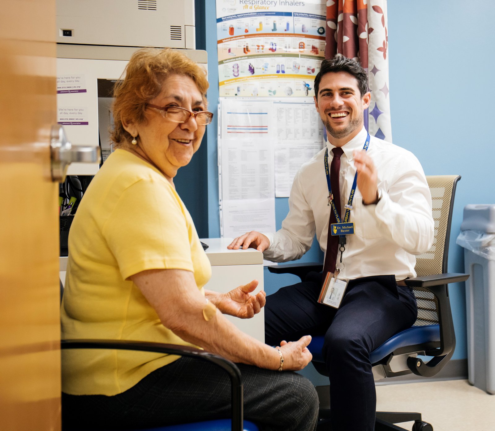 Center for Heathy Aging Patient Maria, and Clinical Pharmacist Michael V. Baxter meet for a consultation at Urban Health Plan, Inc. in Bronx, New York. They laugh along with Maria’s daughter who sits just out of sight.  Urban Health Plan’s Center for Healthy Aging in Bronx, New York aims to use its award funding to improve the health and quality of life of elderly patients and their caregivers through an integrated care team conducting proactive screenings to identify and address patients’ unique needs. Direct Relief along with BD and the National Association of Community Health Centers recently honored Urban Health Plan in Bronx, New York with the “Innovations in Care” award which recognizes health centers in low-resource areas for their success in identifying and assisting vulnerable people manage complex chronic diseases. With the award, Urban Health Plan received a $200,000 grant to build upon their successful work in their Center for Health Aging clinic.